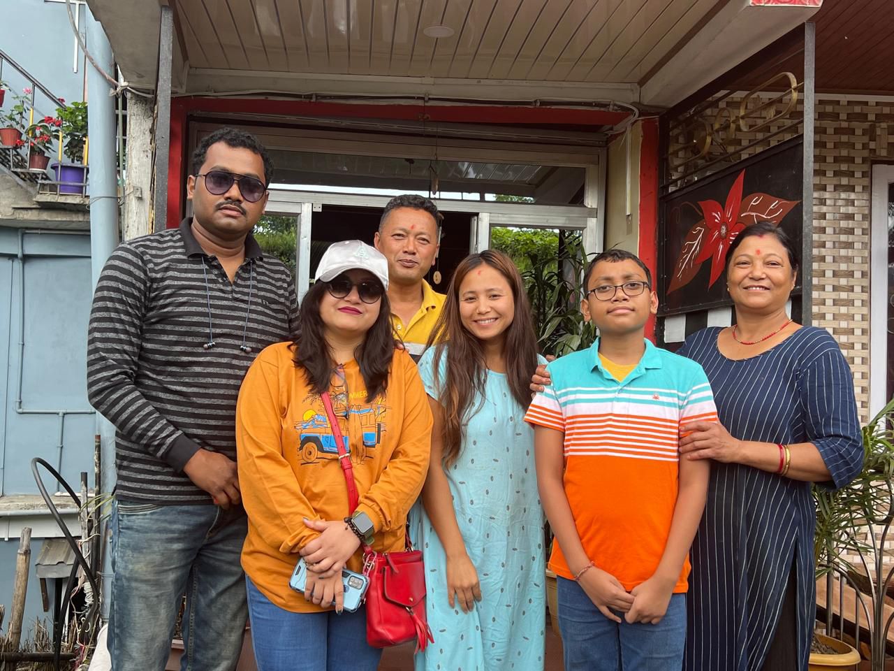 Family group photo at Chandrakala Homestay entrance