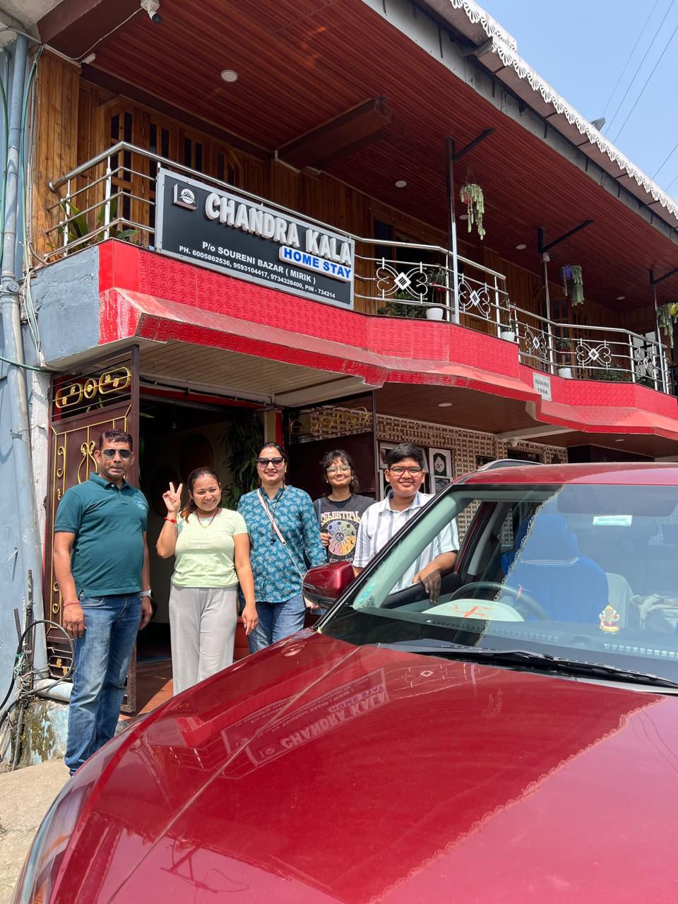 Family group photo with the hosts at Chandrakala Homestay